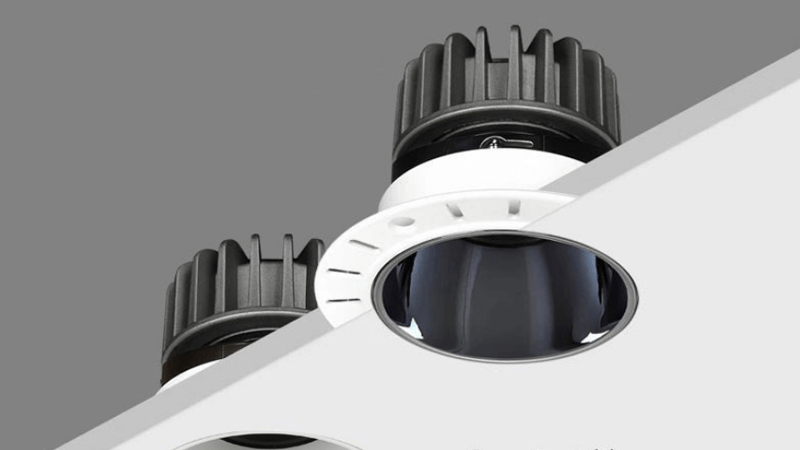 A close-up view of a flangeless recessed light showing the plastered edge