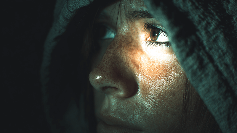 A person squinting from the glare of a poorly baffled COB light