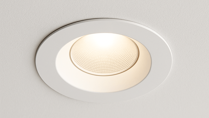 A sleek, trimless downlight flush with a white ceiling