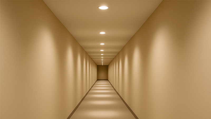 A long hallway with perfectly spaced downlights creating a path of light.