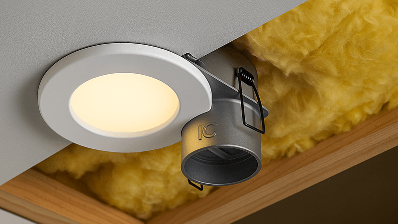 An IC-rated downlight installed safely next to ceiling insulation