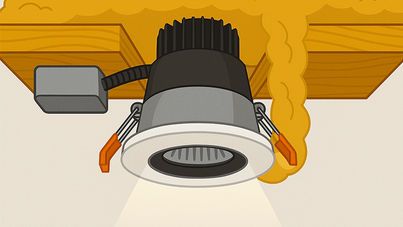 Cutaway view of an IC-rated downlight covered with loft insulation