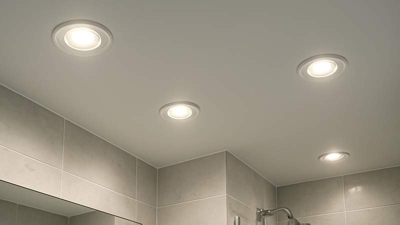 A modern bathroom ceiling with sleek, waterproof LED downlights installed.